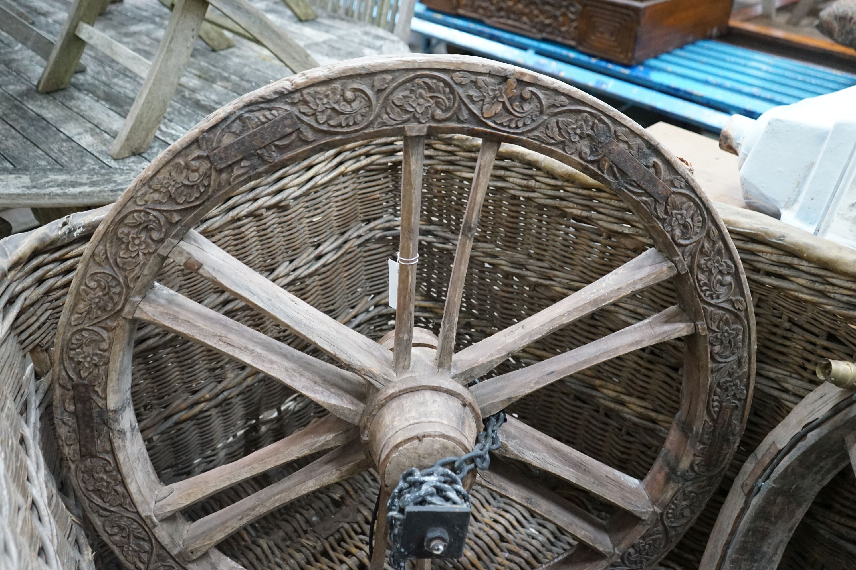 A pair of Continental carved hardwood cartwheels converted to ceiling lights, diameter 83cm